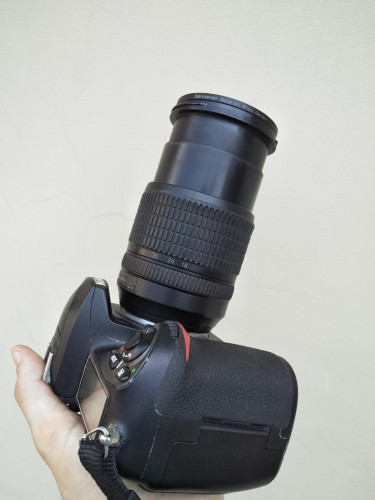 Nikon D200 with a Nikkor 18-105mm lens in good condition