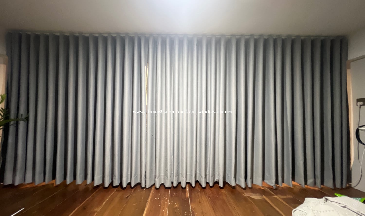 Bed&office space covered by blinds and curtains