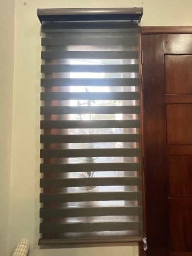 Bed&office space covered by blinds and curtains