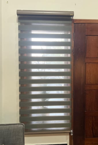Bed&office space covered by blinds and curtains