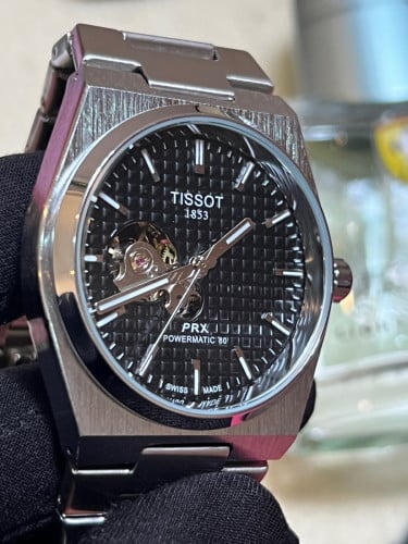 Tissot Automatic PRX Powermatic 80 with a black "Open Heart" dial