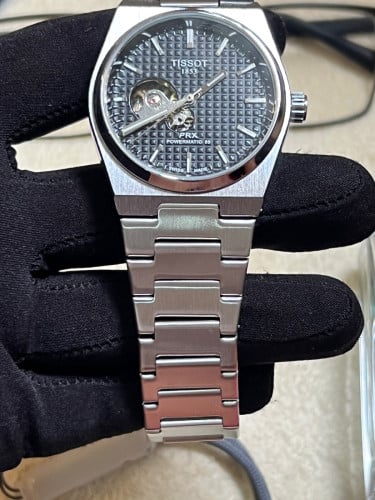 Tissot Automatic PRX Powermatic 80 with a black "Open Heart" dial
